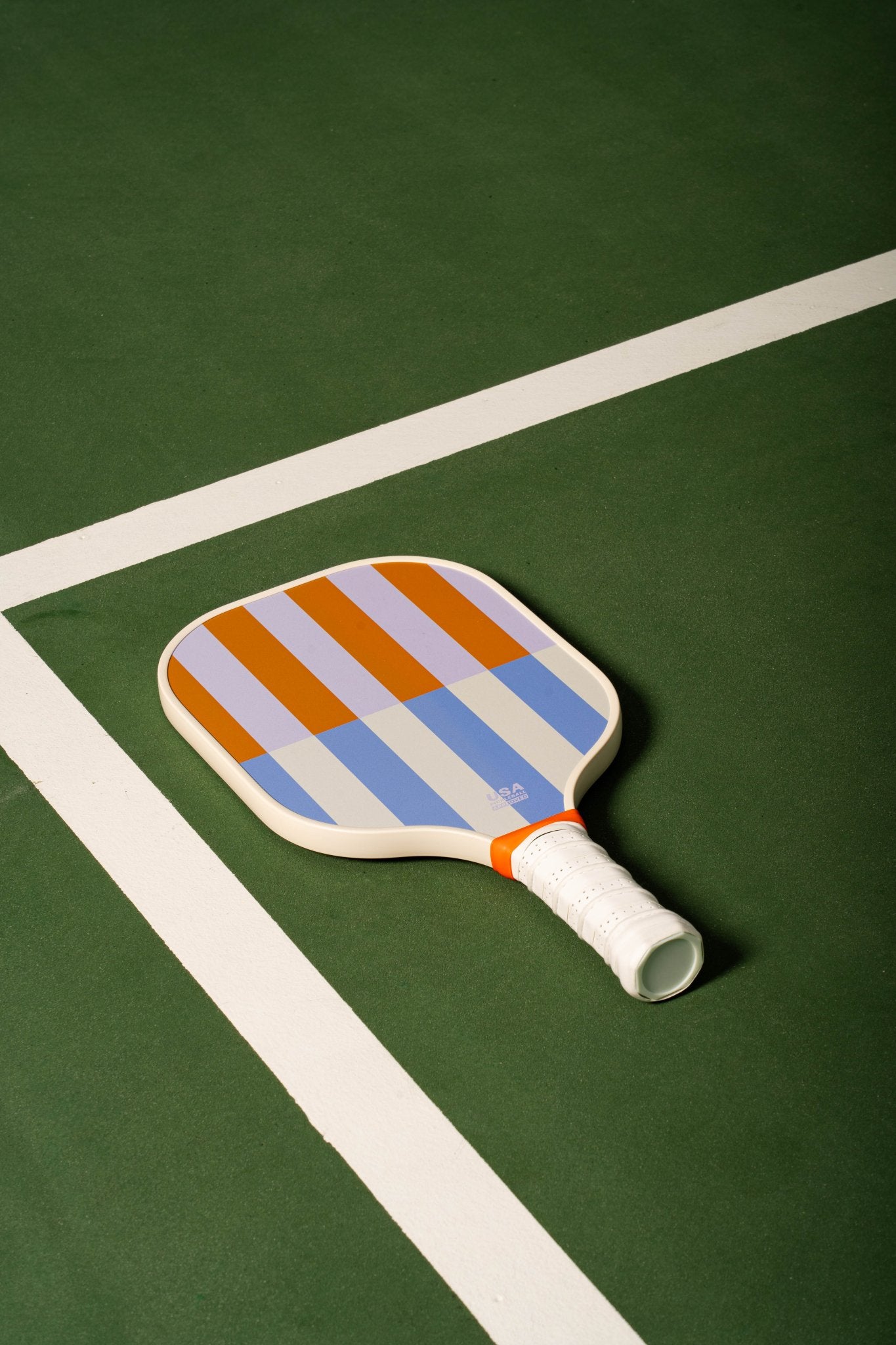 beige, periwinkle, lavender and orange striped pickleball paddle