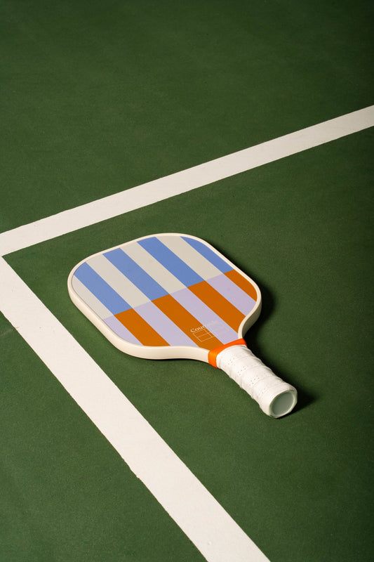 beige, periwinkle, lavender and orange striped pickleball paddle