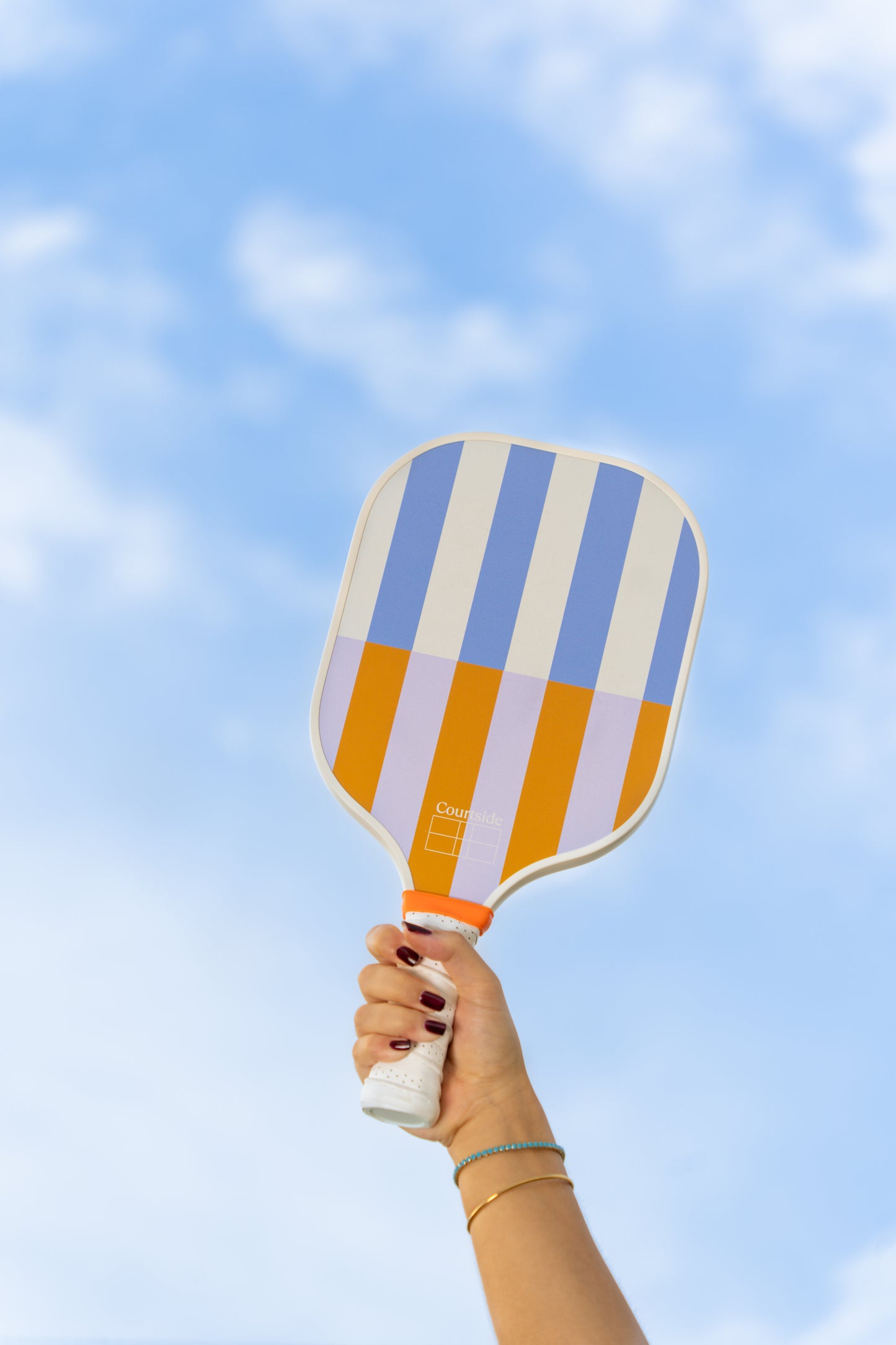 beige, periwinkle, lavender and orange striped pickleball paddle