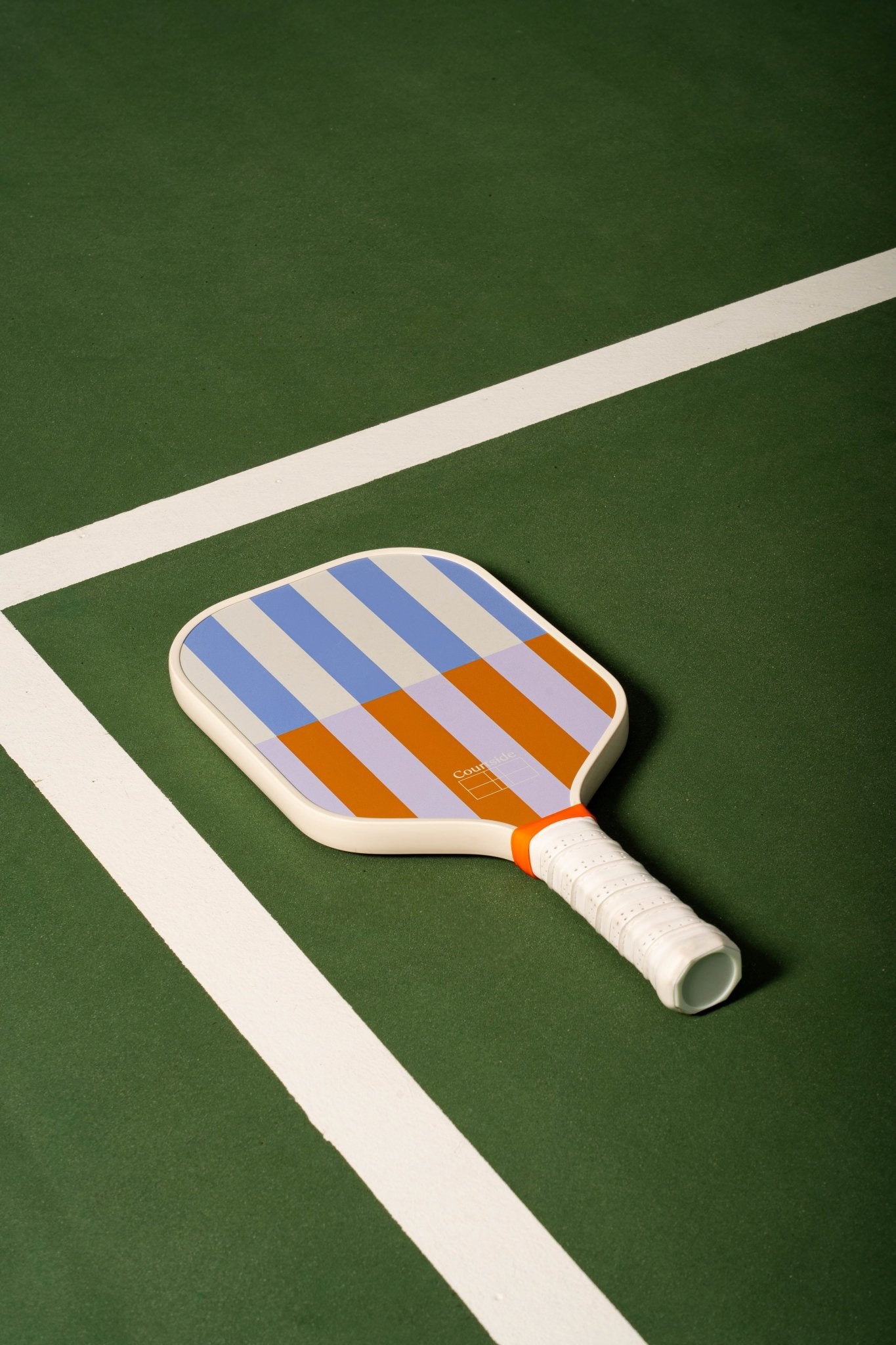 beige, periwinkle, lavender and orange striped pickleball paddle