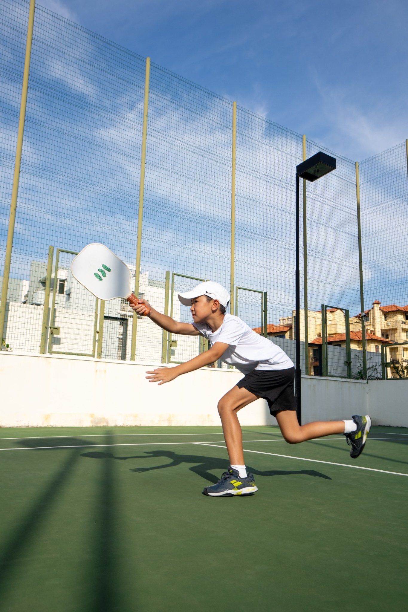 white pickleball ball with cartoon pickles