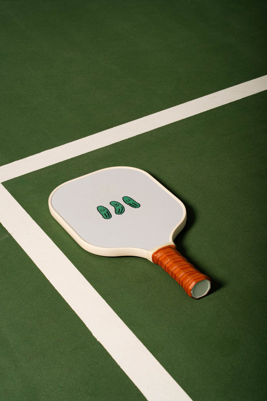 white pickleball ball with cartoon pickles