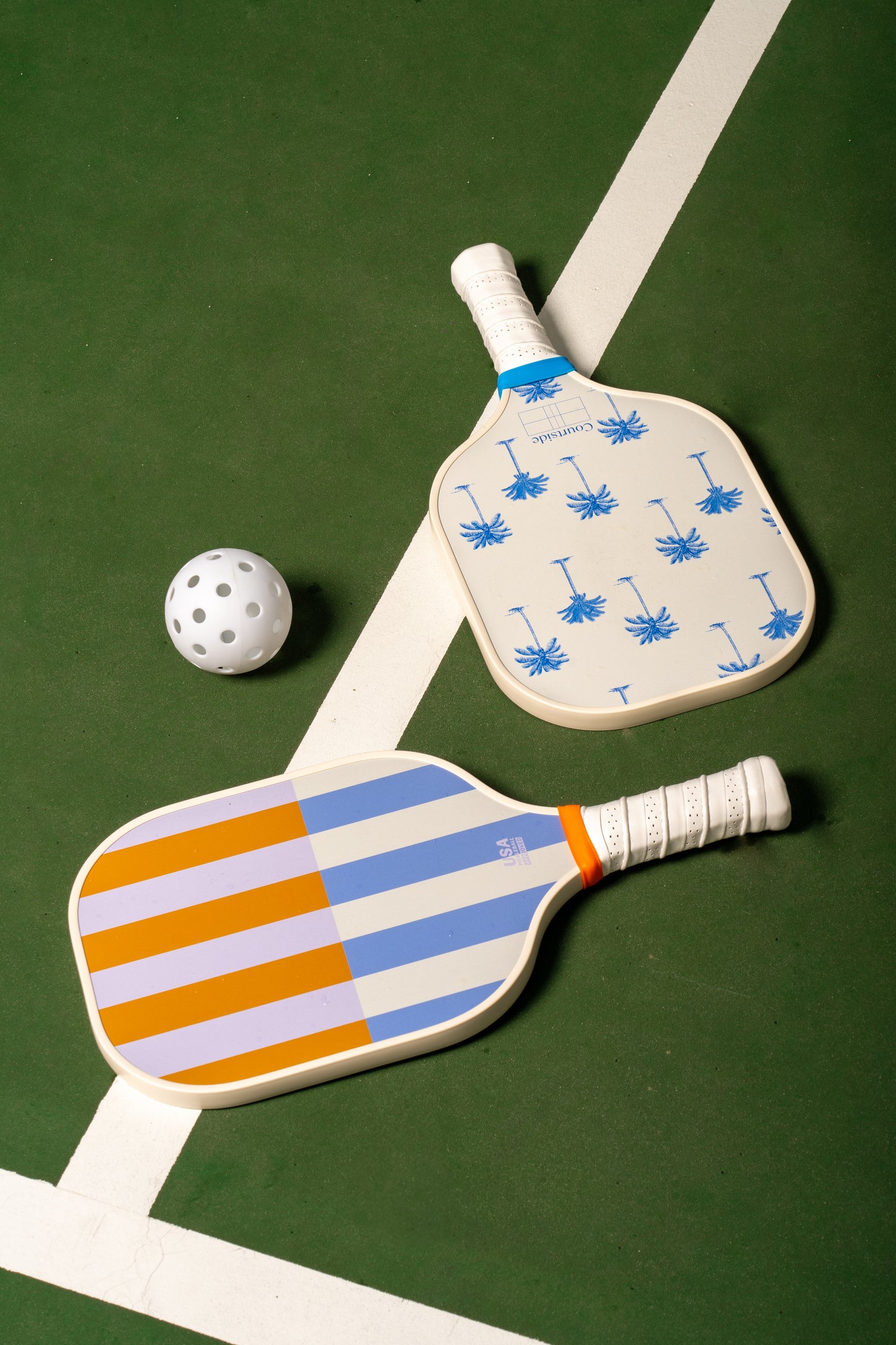 white pickleballs on green court